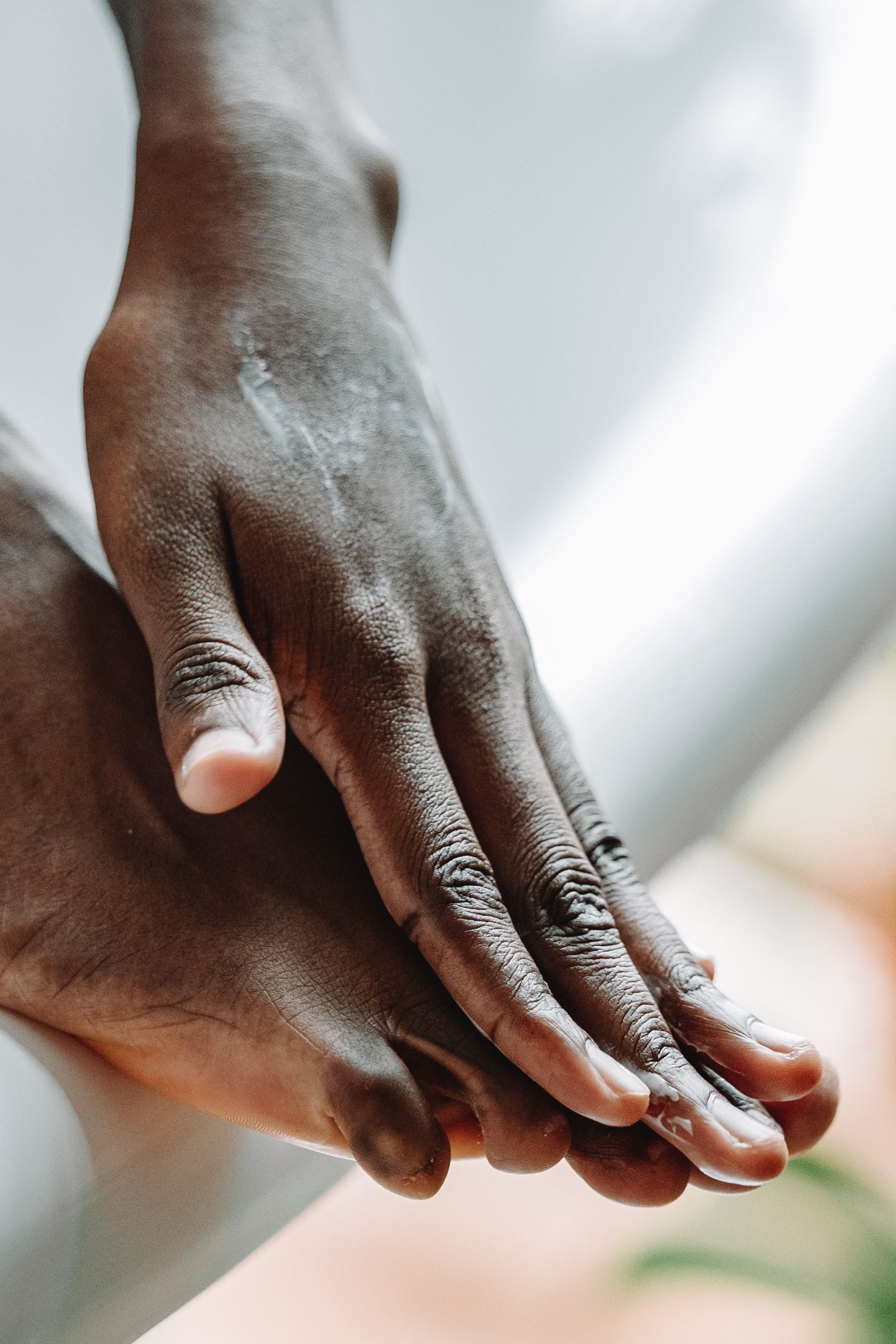 Massaging Soft Step Foot Care Cream into dry feet as part of a daily foot care routine